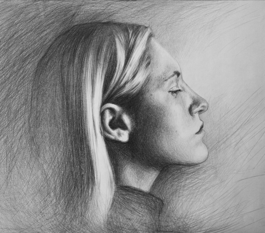 Portrait of a girl, side view, drawing on paper